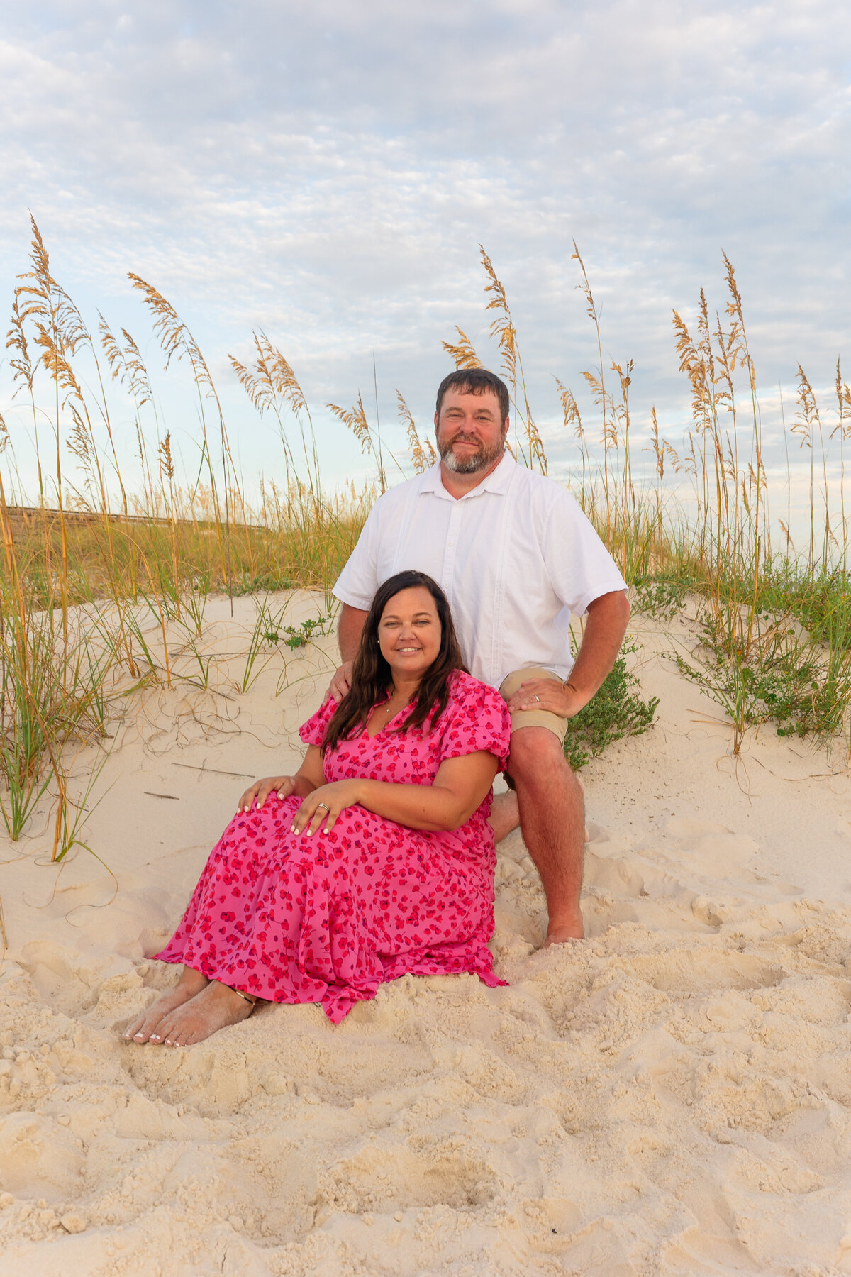 kneeling and sitting in front of sand dune and sea oats in Gulf ShoresPretty in pink 