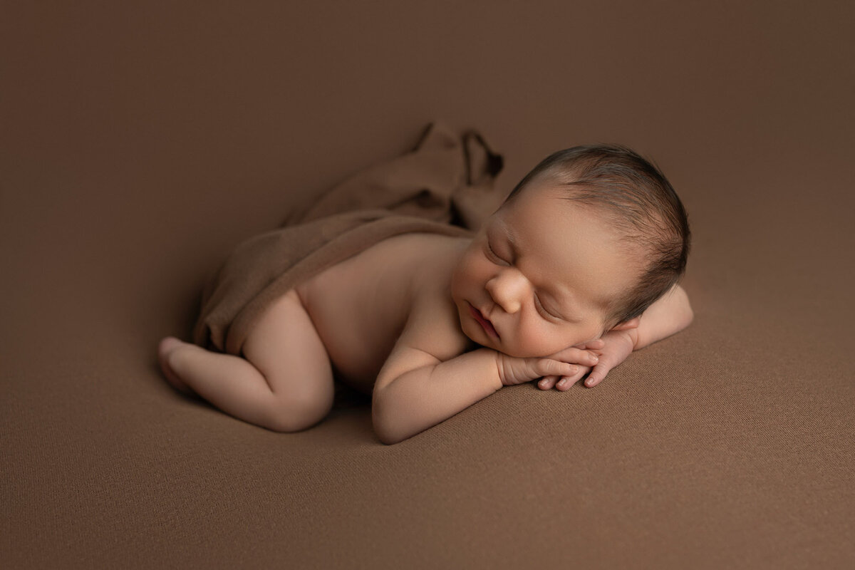 Newborn baby brown backdrop tummy pose Georgetown professional photographer