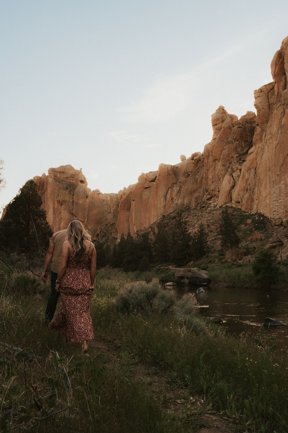 couple walking along the river during golden hour at Smith Rock State Park