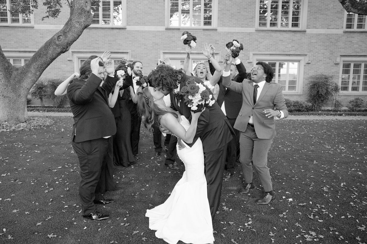 Bride and groom exit wedding ceremony with guests cheering and confetti flying at San Antonio venue