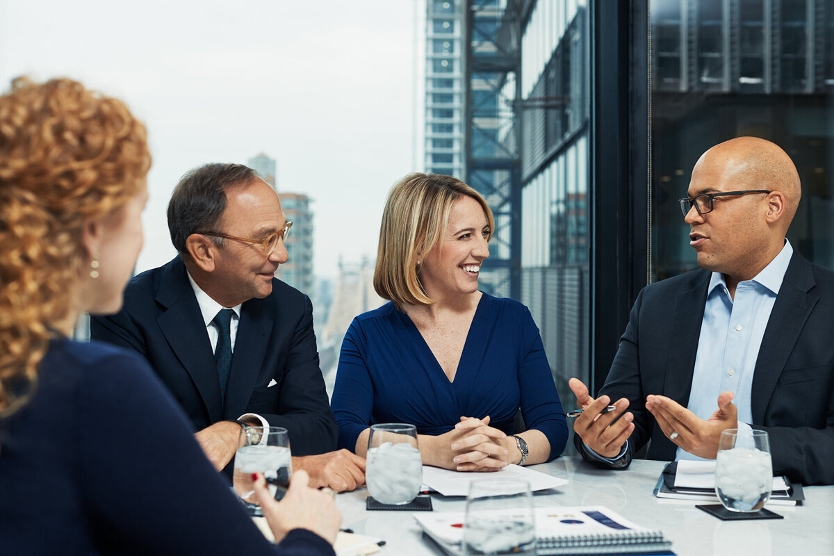 Team gathered around a conference table for a boardroom discussion in Cornell Capital Offices, captured by Ylva Erevall.