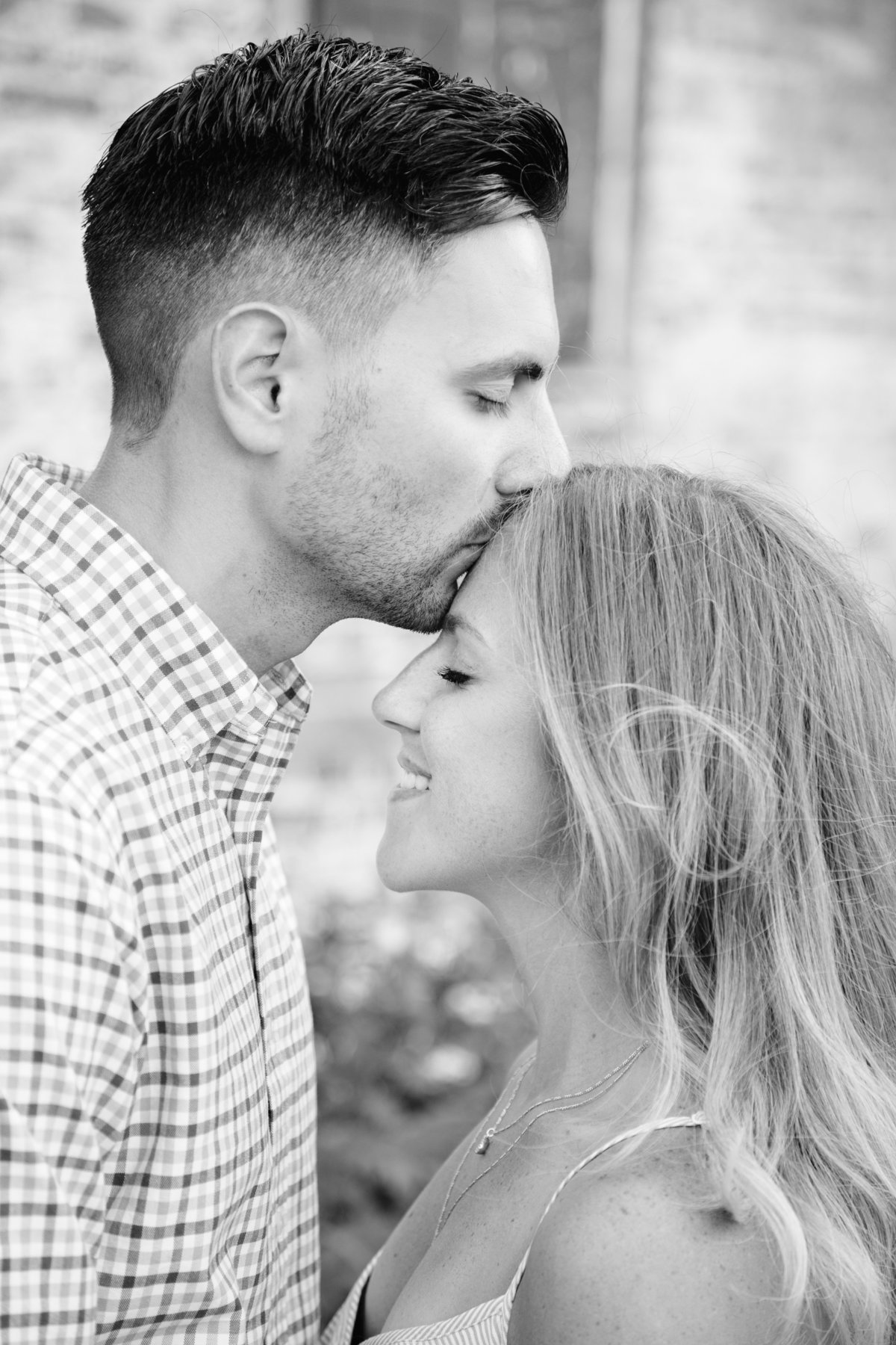 engaged couple kiss at laurita winery
