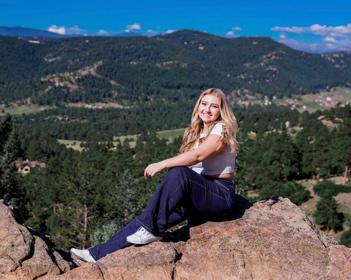 senior photography denver - teen girl sitting on rocks