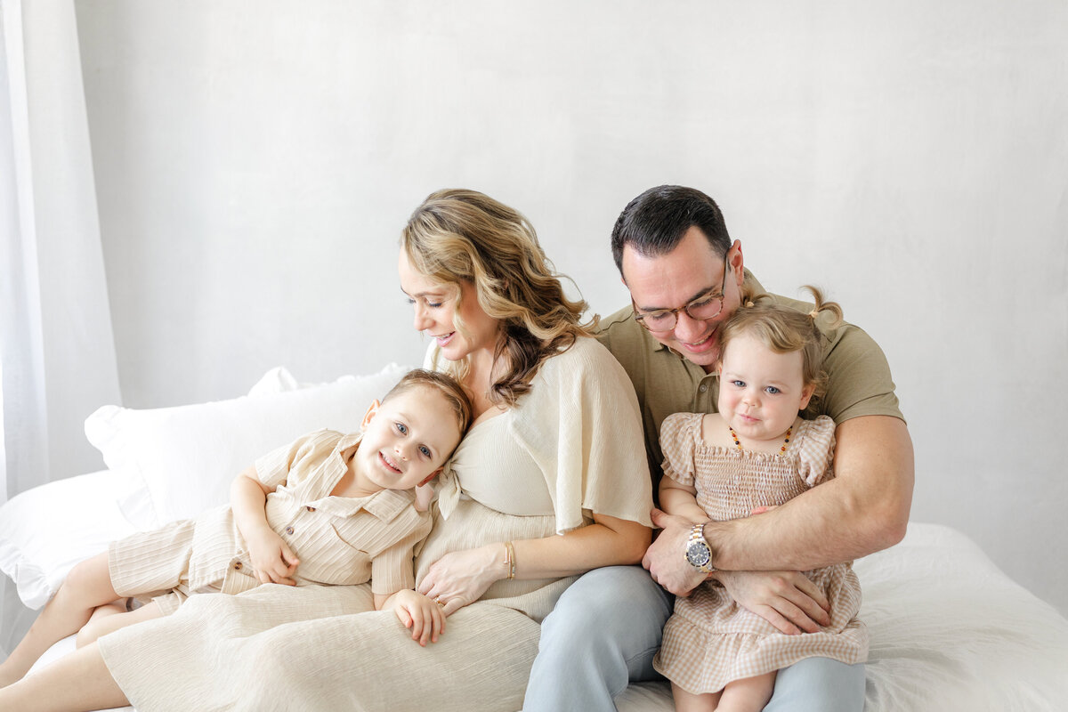 Classic studio maternity portrait of Katie and family, captured in natural light in Tampa