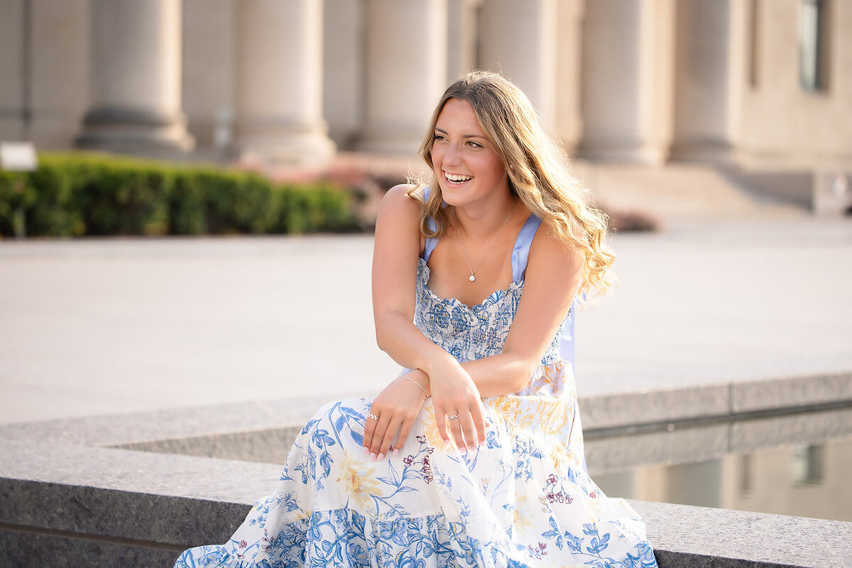 Senior girl laughing with Nelson Atkins Art Museum in background