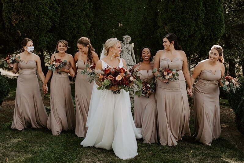 Bride and bridesmaids holding fall bouquets at a farm in Loudoun County, VA