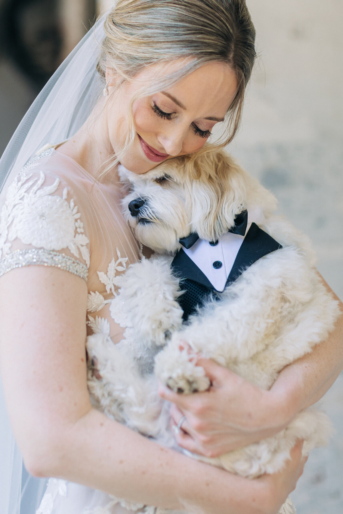 bride hugging her dog before the wedding
