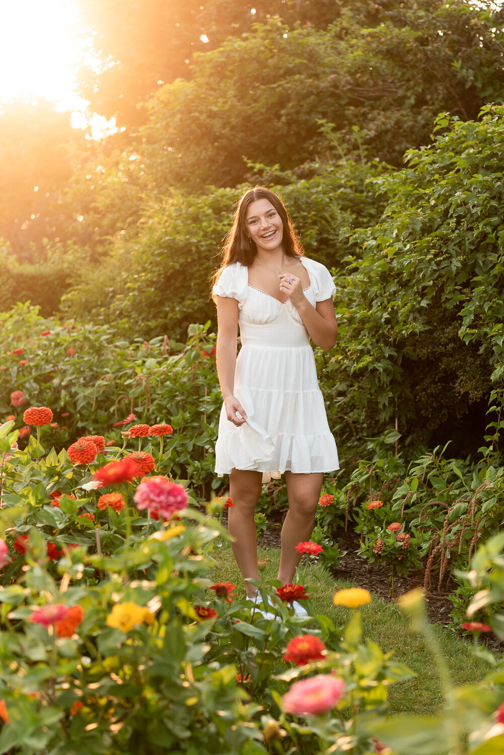 Senior girl smiling at the camera in a garden of flowers |Sharon Leger Photography | Canton, CT Newborn & Family Photographer