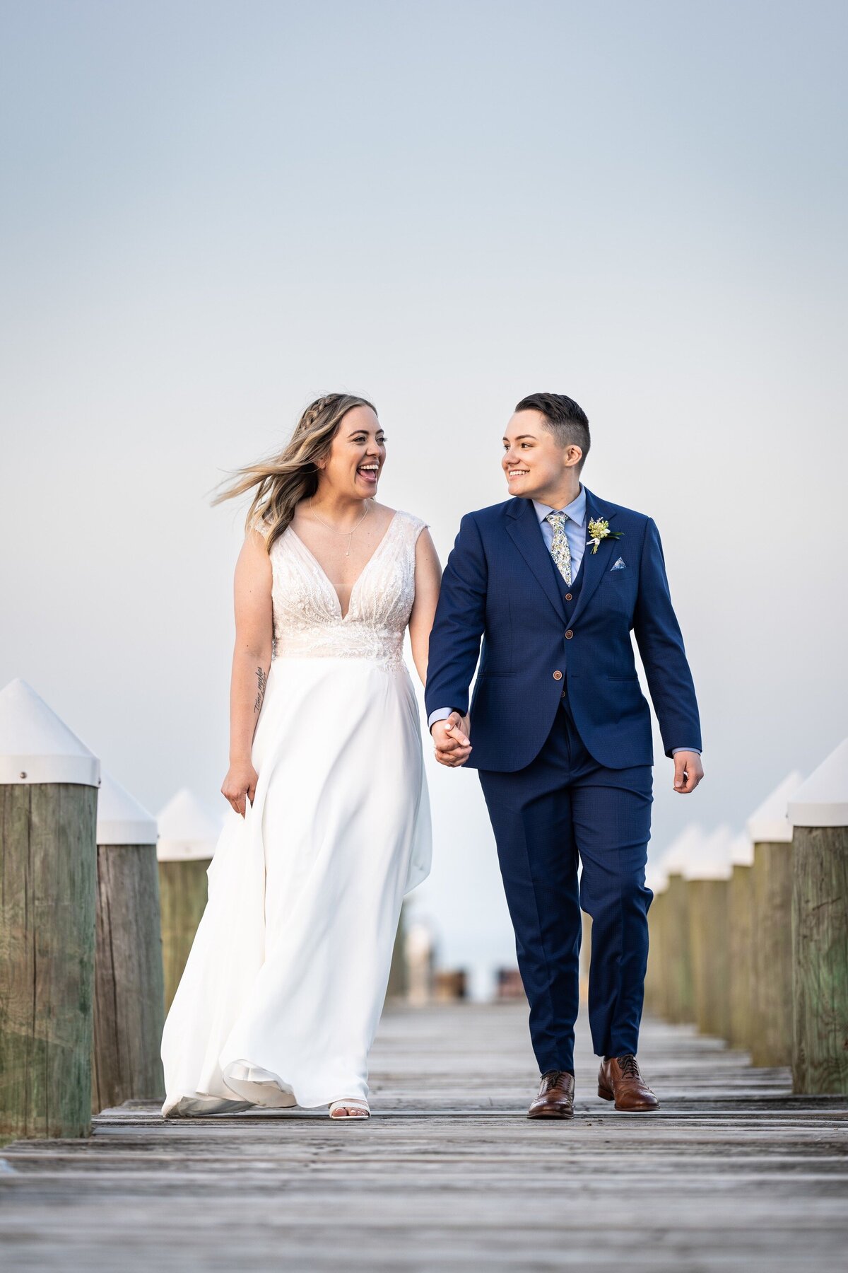 Couple walking on dock at Bay Waveland Yacht Club wedding
