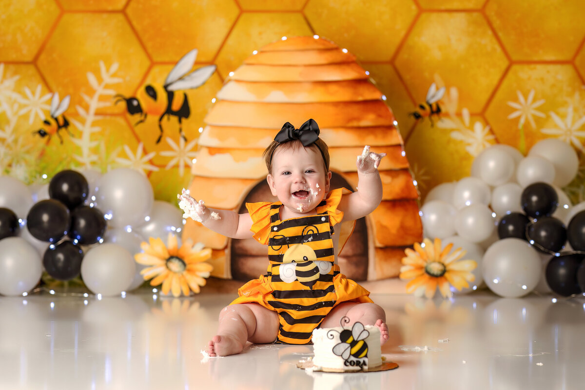 One year old Tampa baby enjoying a personalized luxury cake smash session with playful decorations