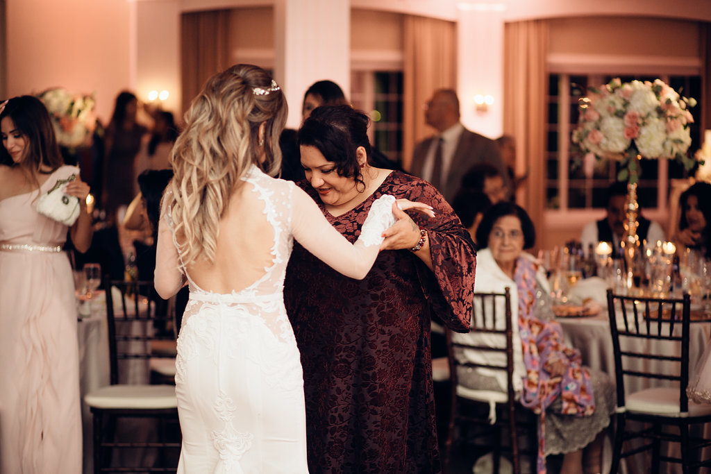 Wedding Photograph Of Bride Dancing With a Woman In Maroon Dress Los Angeles