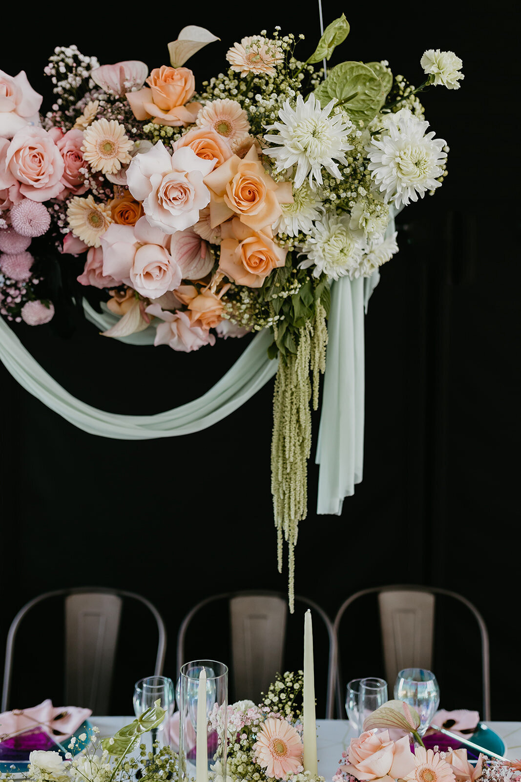 Colourful and trendy florals of pink, orange, and white hanging at 52 North Venue, an industrial and unique wedding venue in Sylvan Lake, AB, featured on the Brontë Bride Vendor Guide.52 North Venue, an industrial and unique wedding venue in Sylvan Lake, AB, featured on the Brontë Bride Vendor Guide.