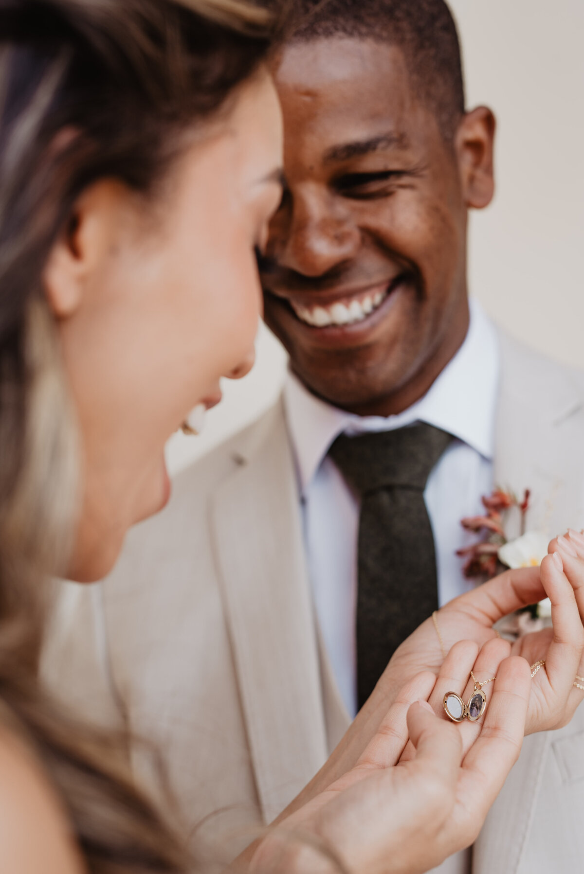 Utah Elopement Photographer captures woman smiling at locket