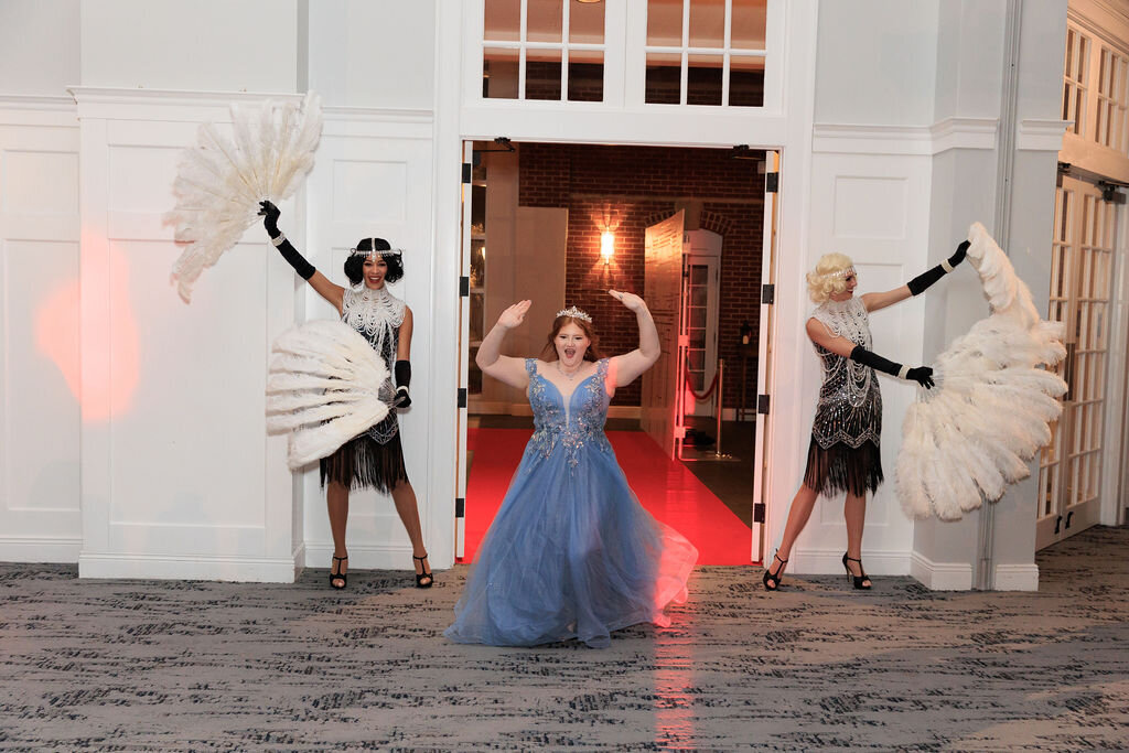 Sweet 16 girl entering party with feather fan showgirls