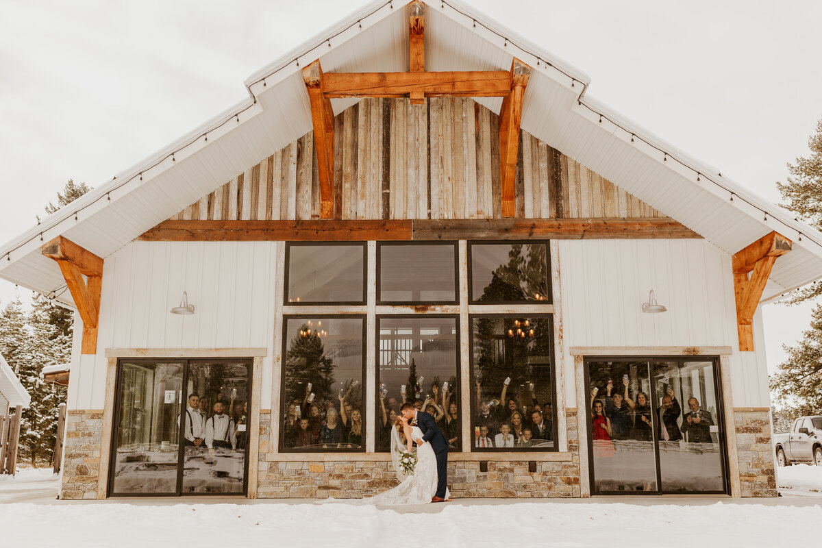 bride and groom kissing by cabin