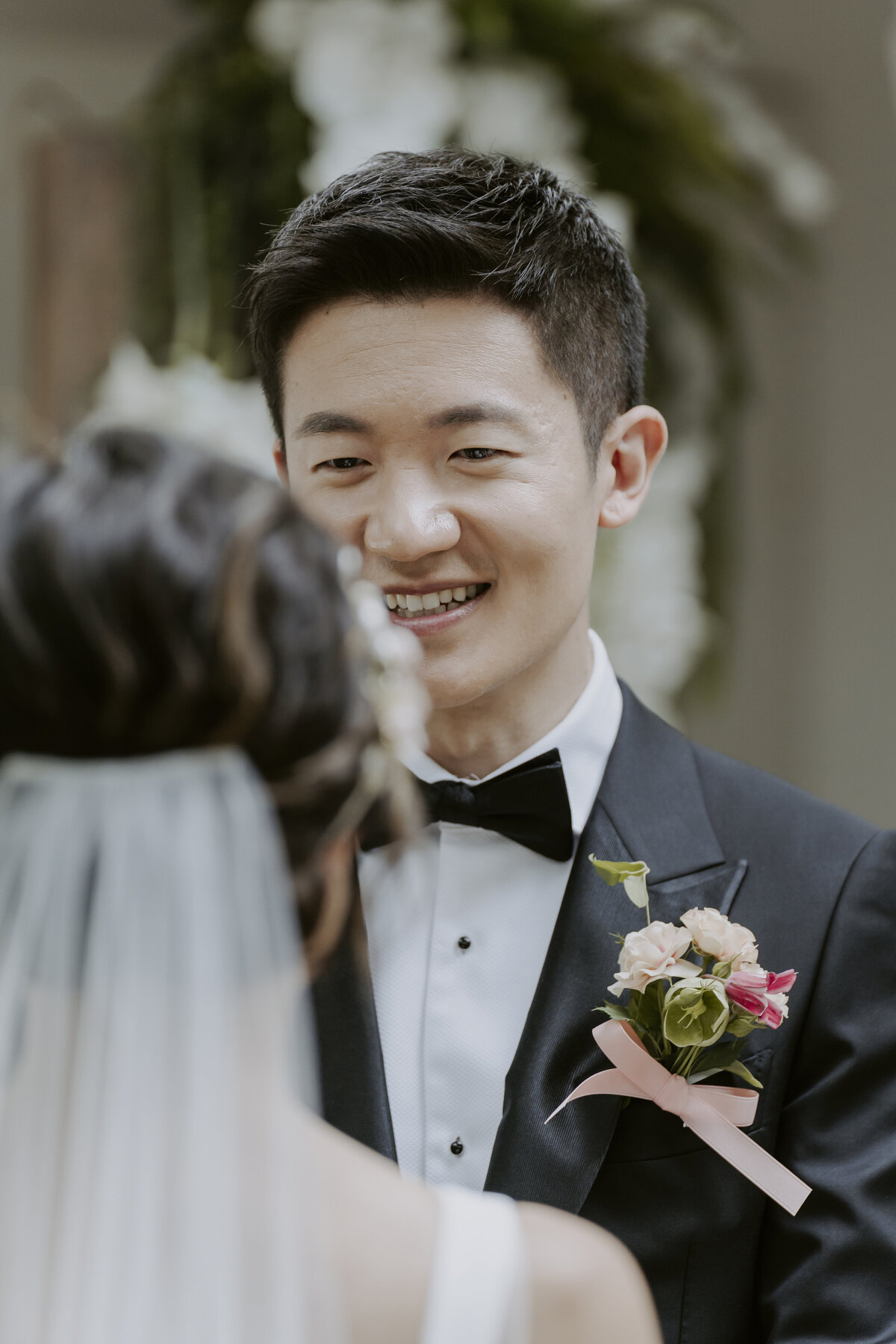 the groom smiling at the bride