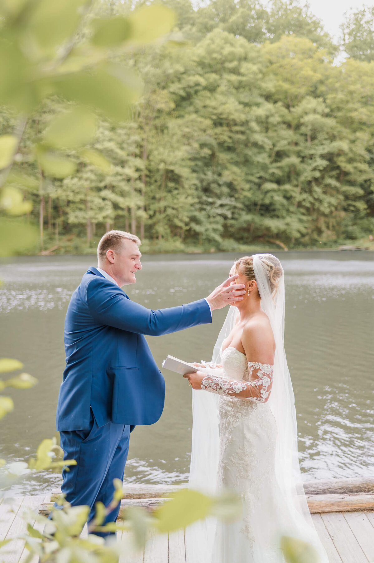 Groom wipes bride's tears during their private vows captured by Pittsburgh wedding photographer Bree Stewart of LLP.