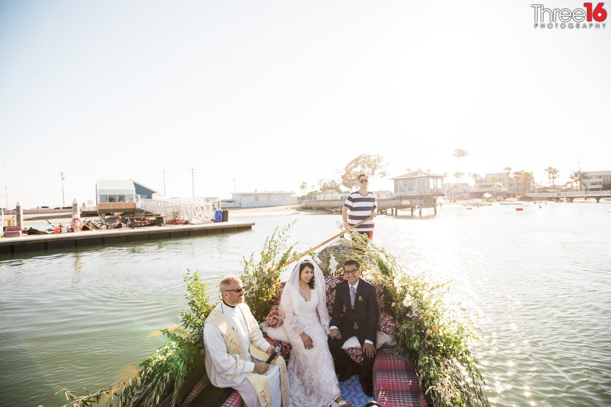 Bride and Groom sit with the Officiant on gondola at a Gondola Getaway wedding off Long Beach Harbor