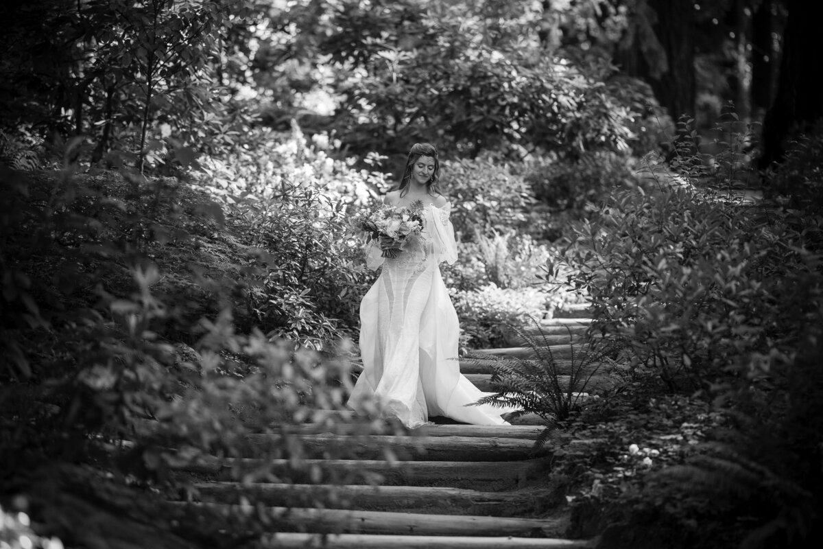 A bride walks down the steps towards her ceremony at a destination wedding at Nestldown in Los Gatos, California