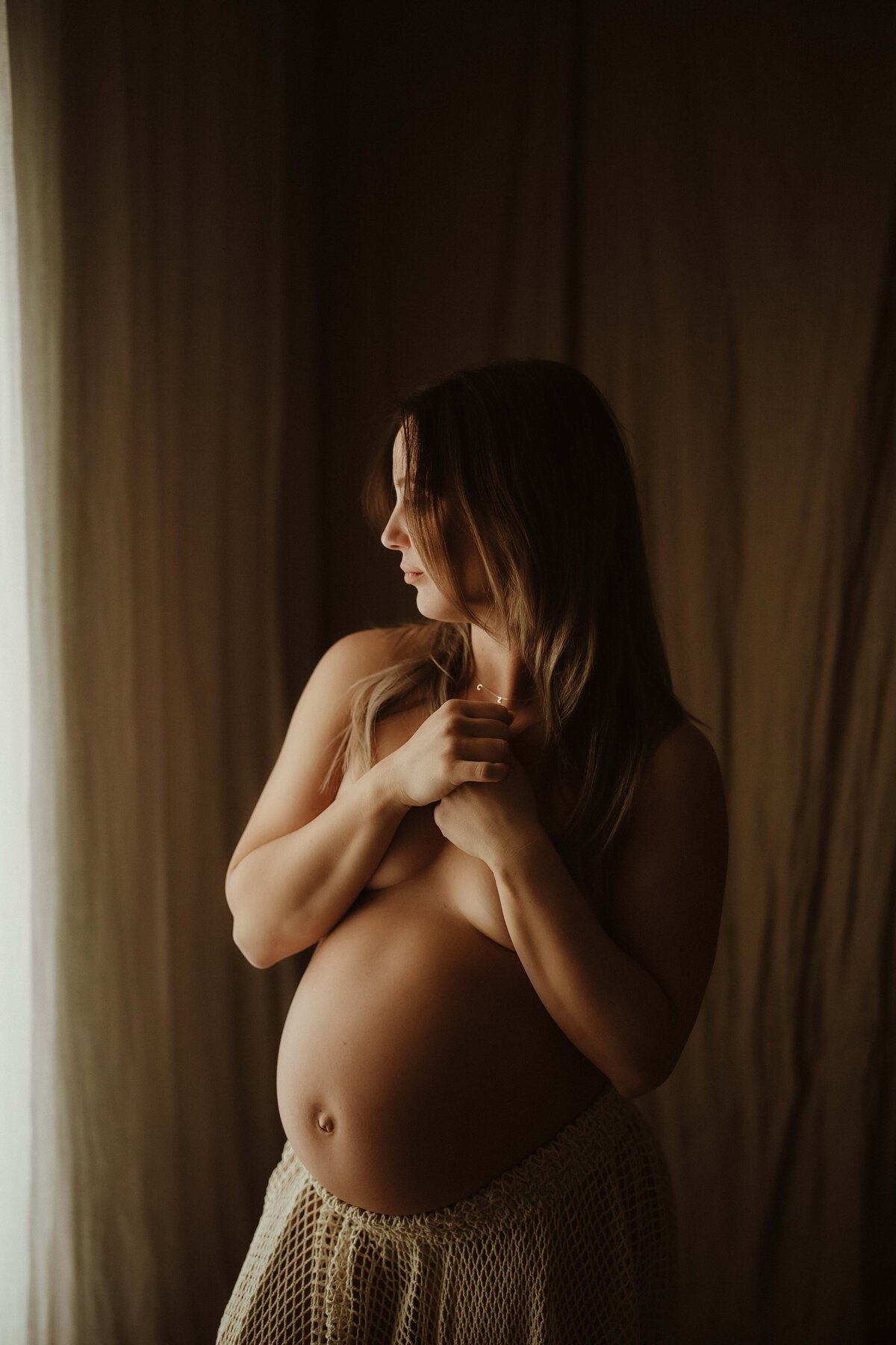 Mother-to-be posing in natural light studio session, Sydney maternity photographer.