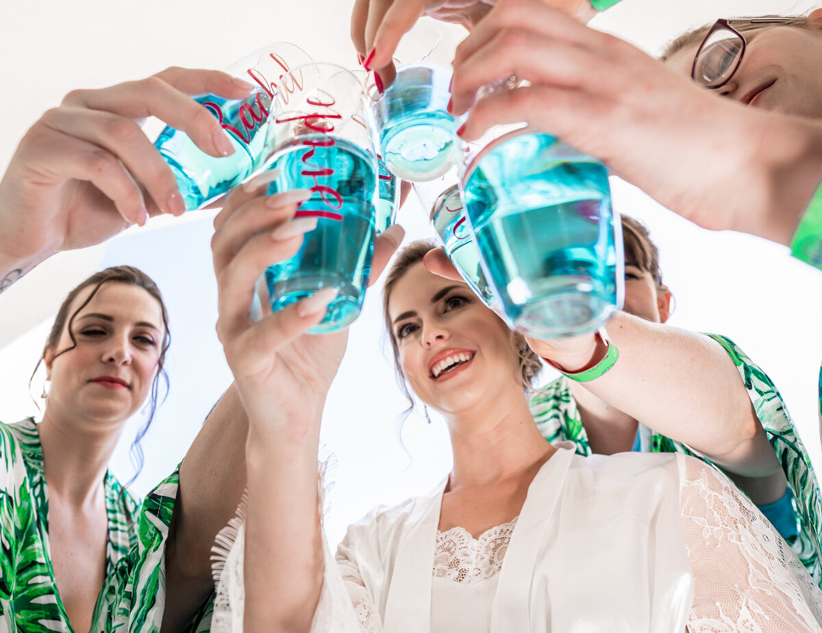 bride and bridesmaid drinking and cheering
