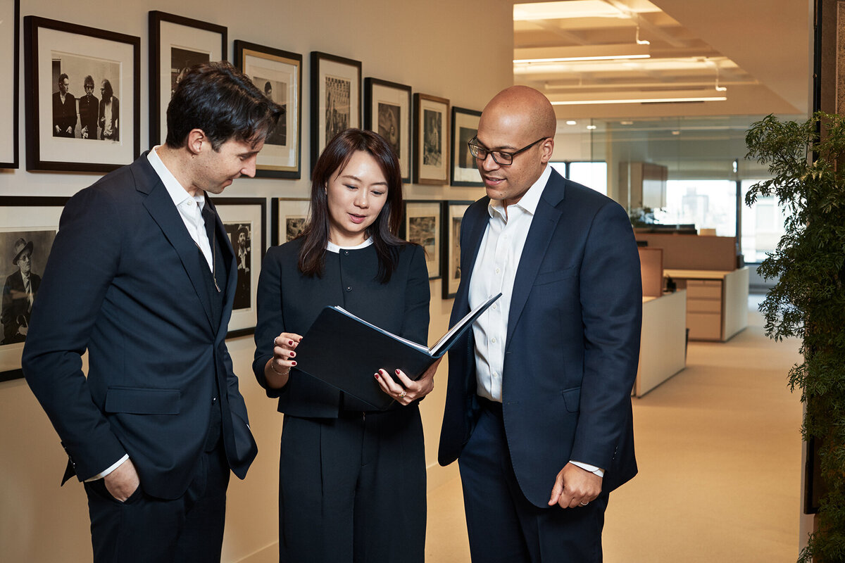 Corporate team collaborating in a formal office environment at Cornell Capital Offices, highlighting teamwork and engagement, shot by Ylva Erevall.