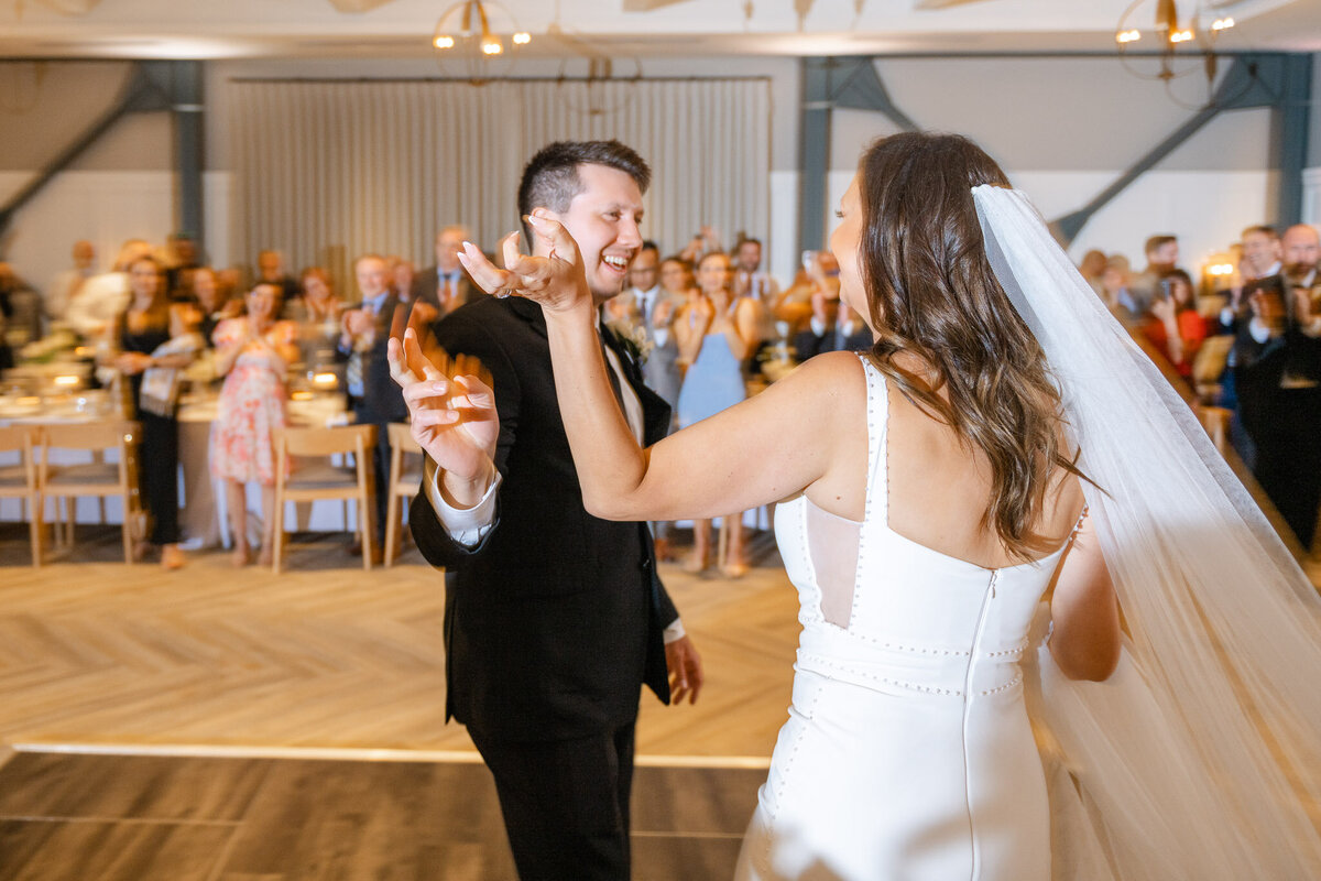The newlyweds share their first dance at their Lido House wedding reception in Newport Beach, surrounded by joyful guests