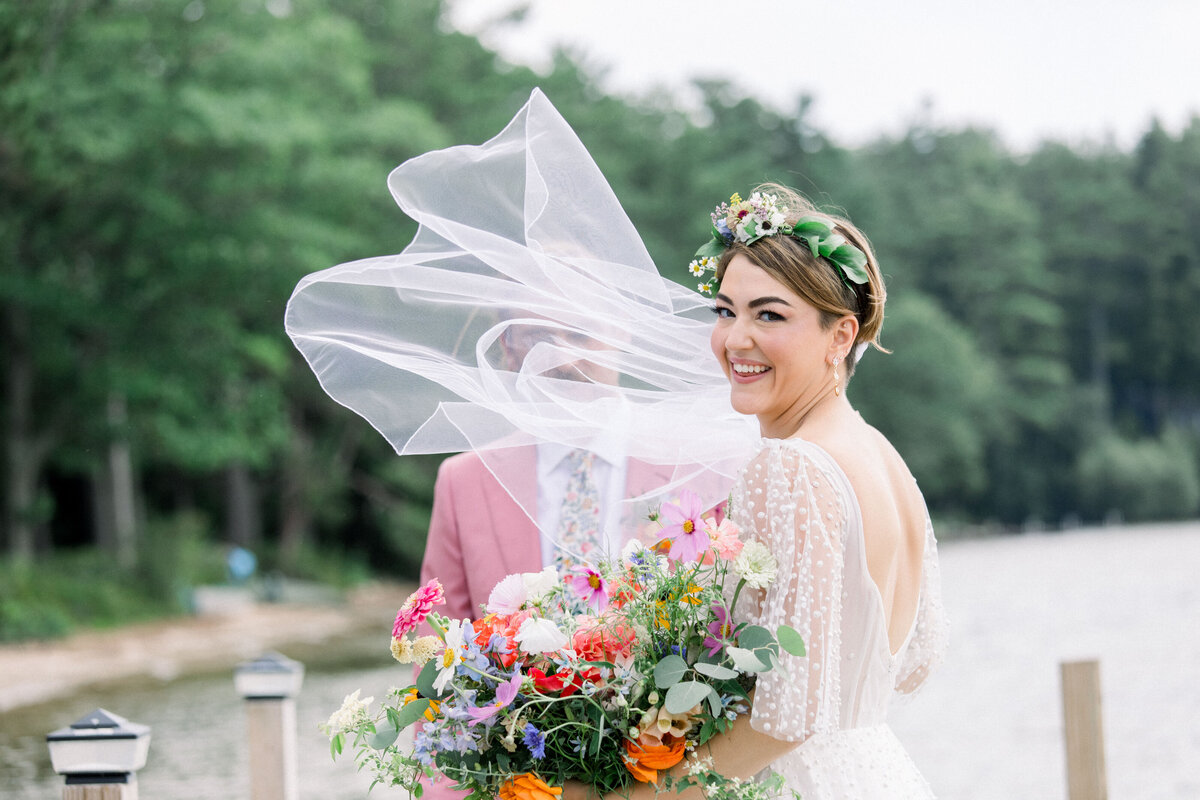 bride with veil flowing in the wind at Lake Winnipesaukee wedding