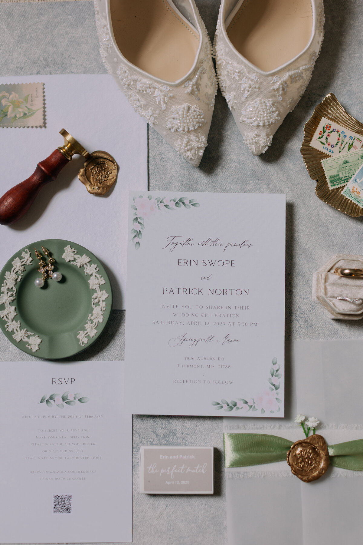 Wedding flatlay featuring invitation suite, wax seal, bridal shoes, and florals styled at Springfield Manor.