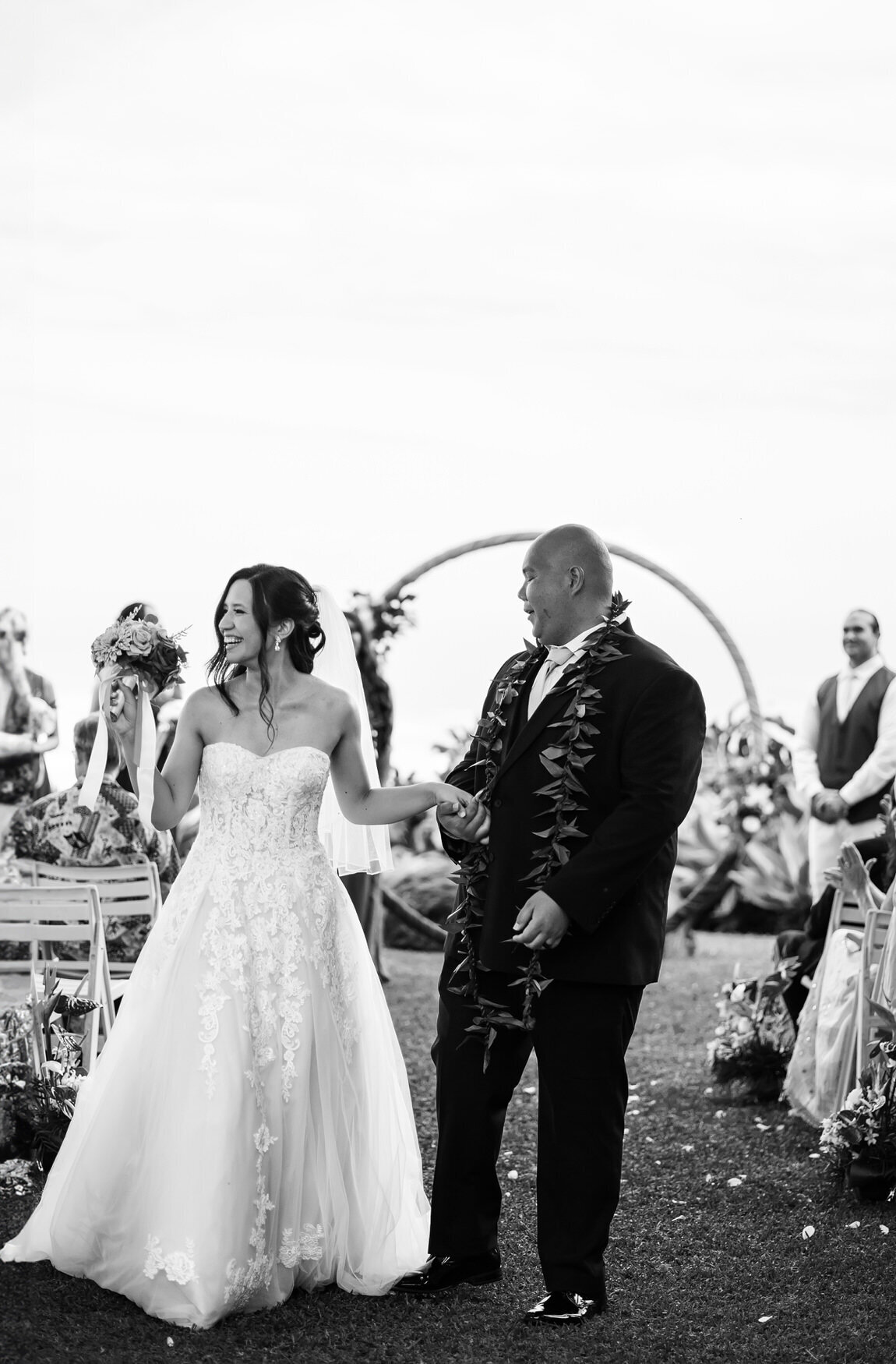 bride and groom laughing walking down the aisle