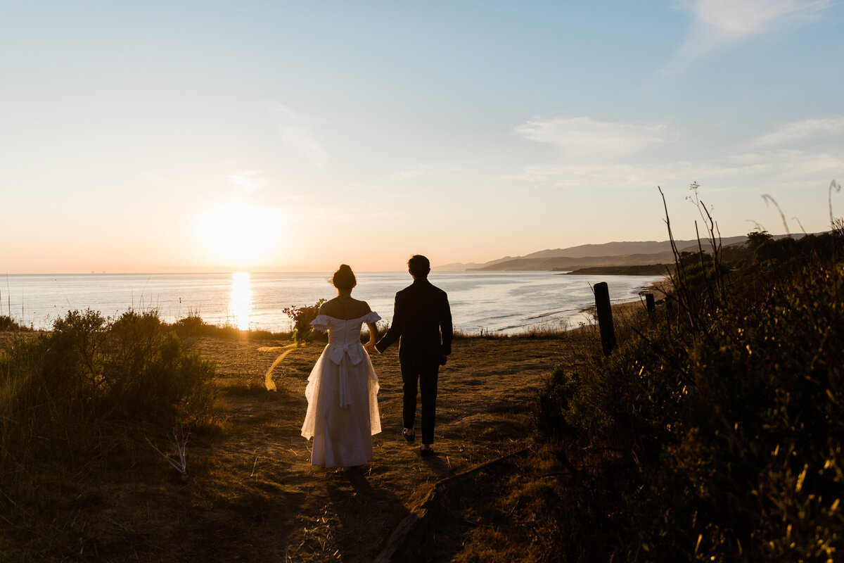 A candid portrait of the bride and groom after their wedding as the sun sets over the cliffs of Dos Pueblos Orchid Farm, photographed on film by Megan Lynn of My Sun and Stars Co.