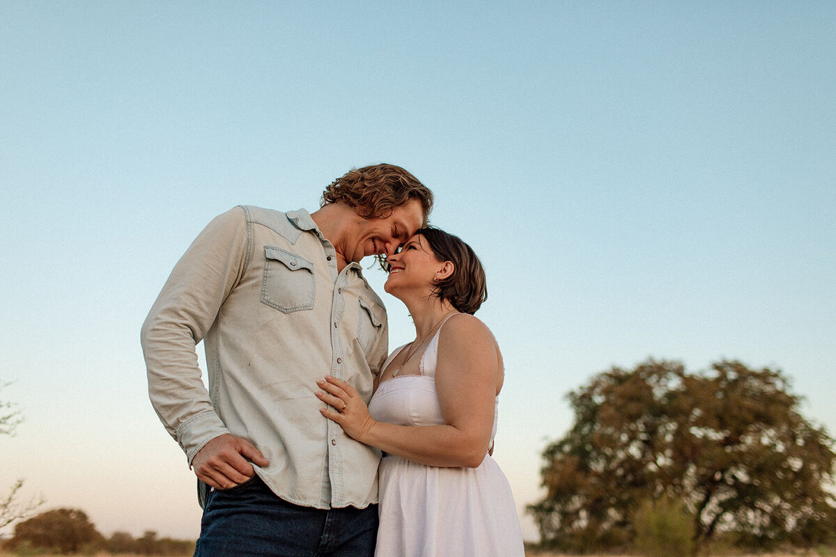 Intimate couple embracing in golden field - Sara James San Antonio photographer creates romantic portraits and couples sessions capturing love and connection in beautiful Texas outdoor locations