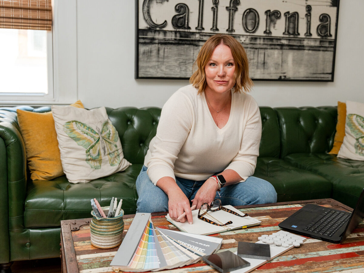 Construction project manager at home with different building finishes layed out on her coffee table