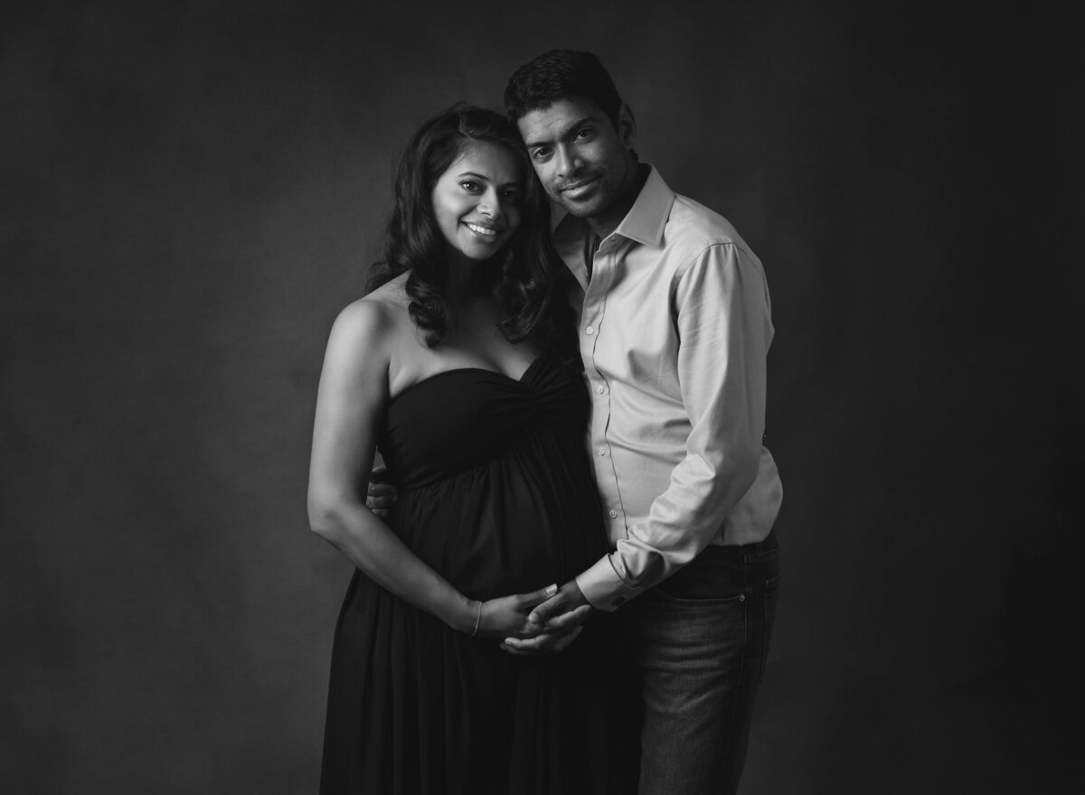 black and white maternity portrait of couple in the studio