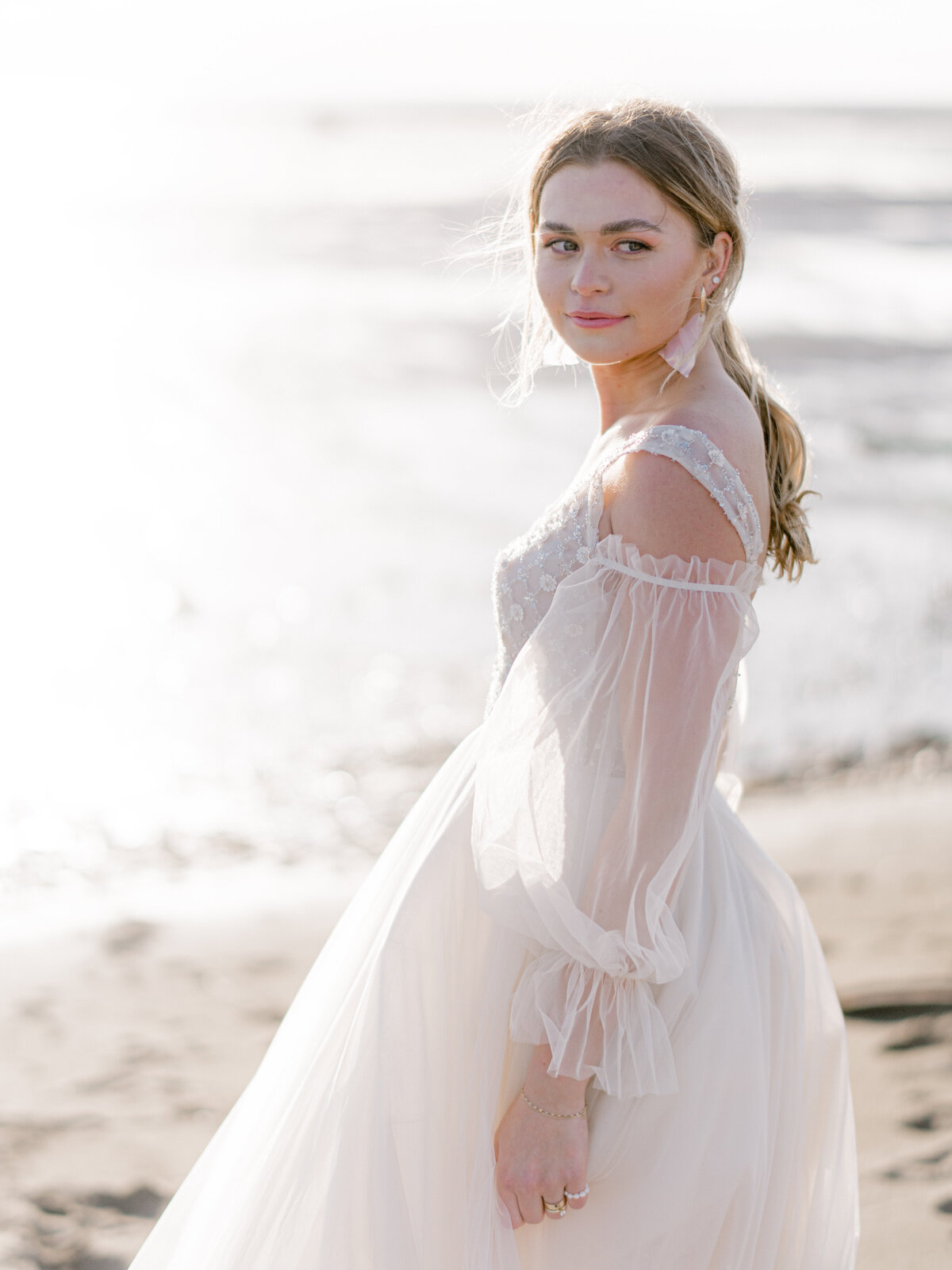 Stunning bride on the beach featuring hair and makeup by Allysa Helm Beauty, natural glam Vancouver & Ontario hair and makeup artist, featured on the Brontë Bride Vendor Guide.