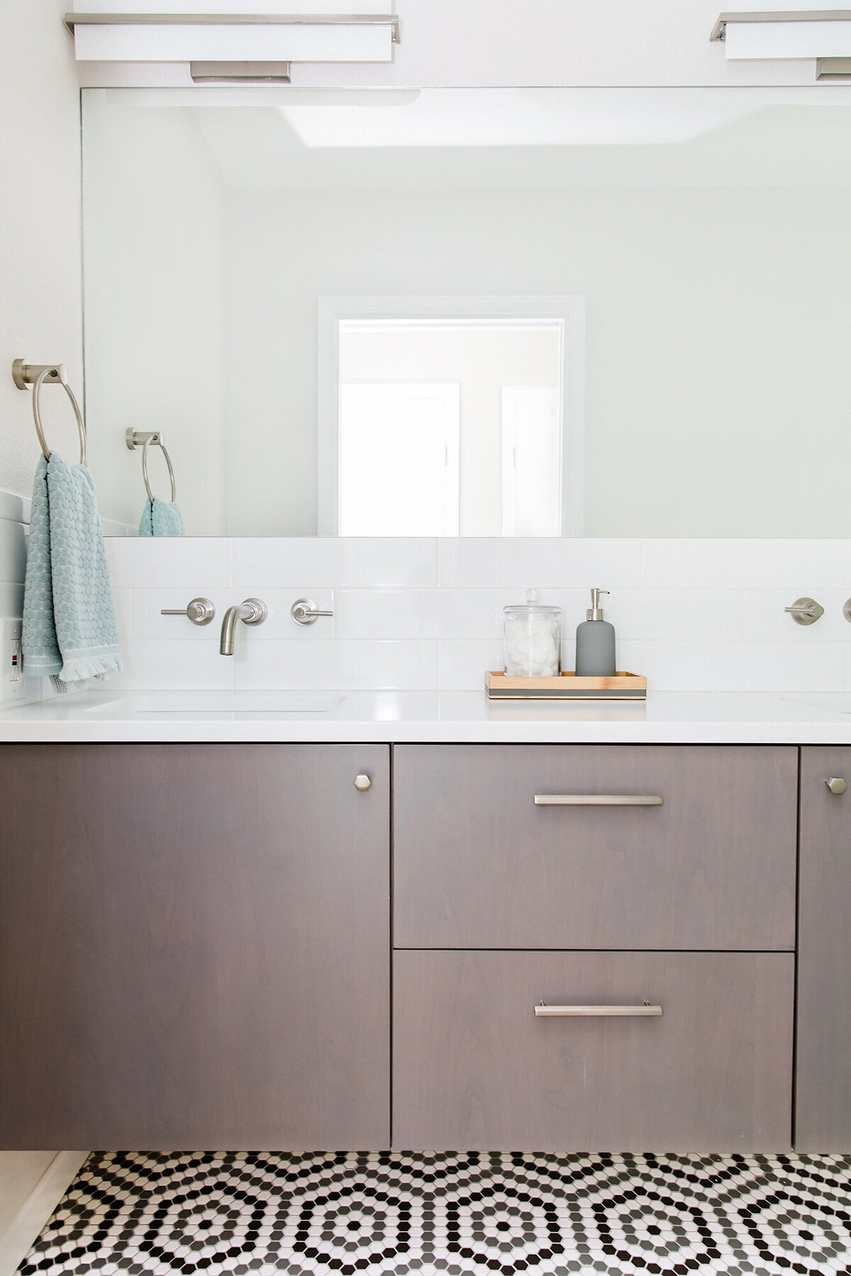 Fresh modern bathroom remodel with floating vanity and hex floor tile - Interior design by Patina Living Co.