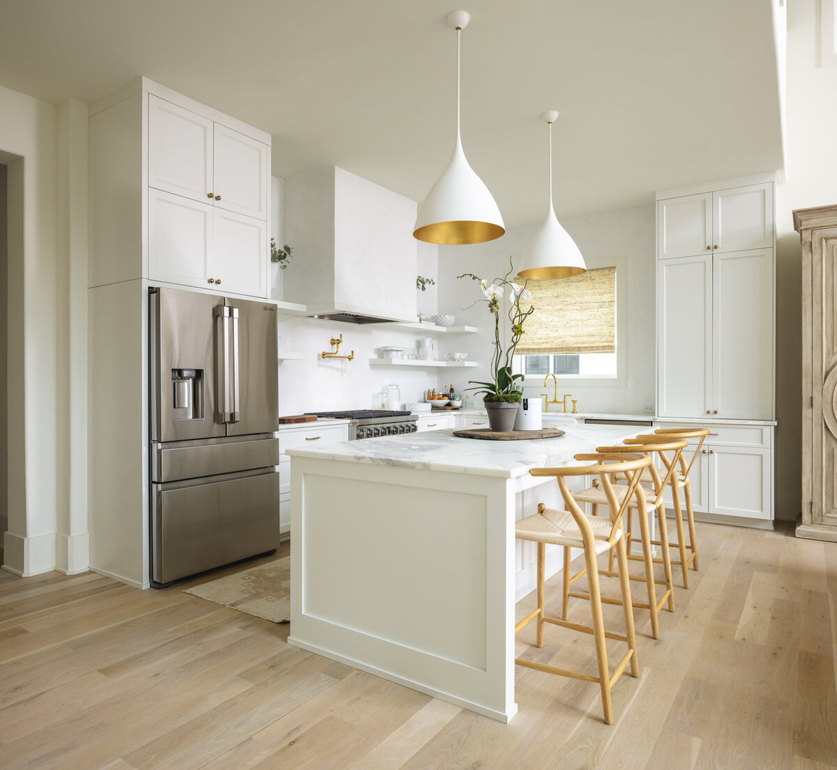White and gold kitchen design with wood floor