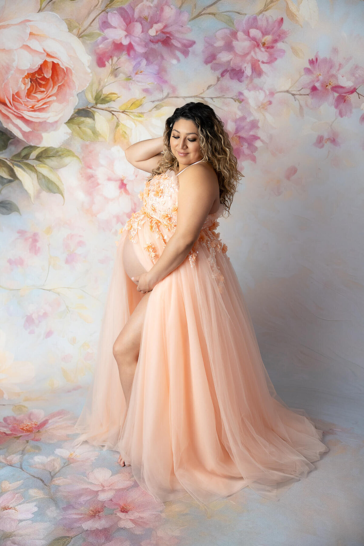 Full length maternity photo with couture gown flowing across floor