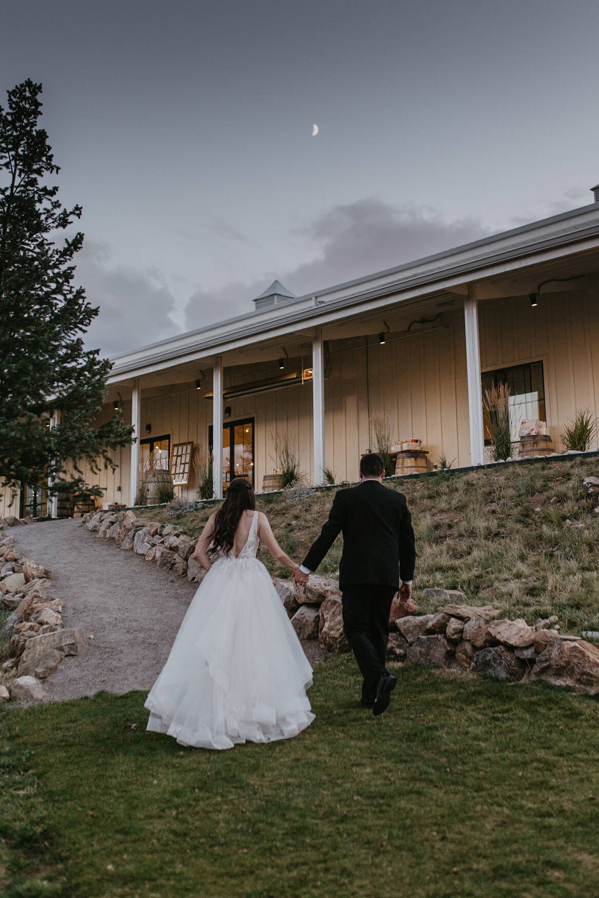 bride and groom walk up path