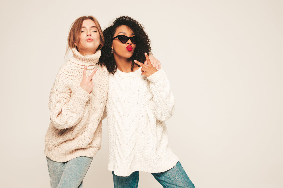 two-young-beautiful-smiling-hipster-girls-trendy-winter-sweaters-positive-models-having-fun-hugging (1)