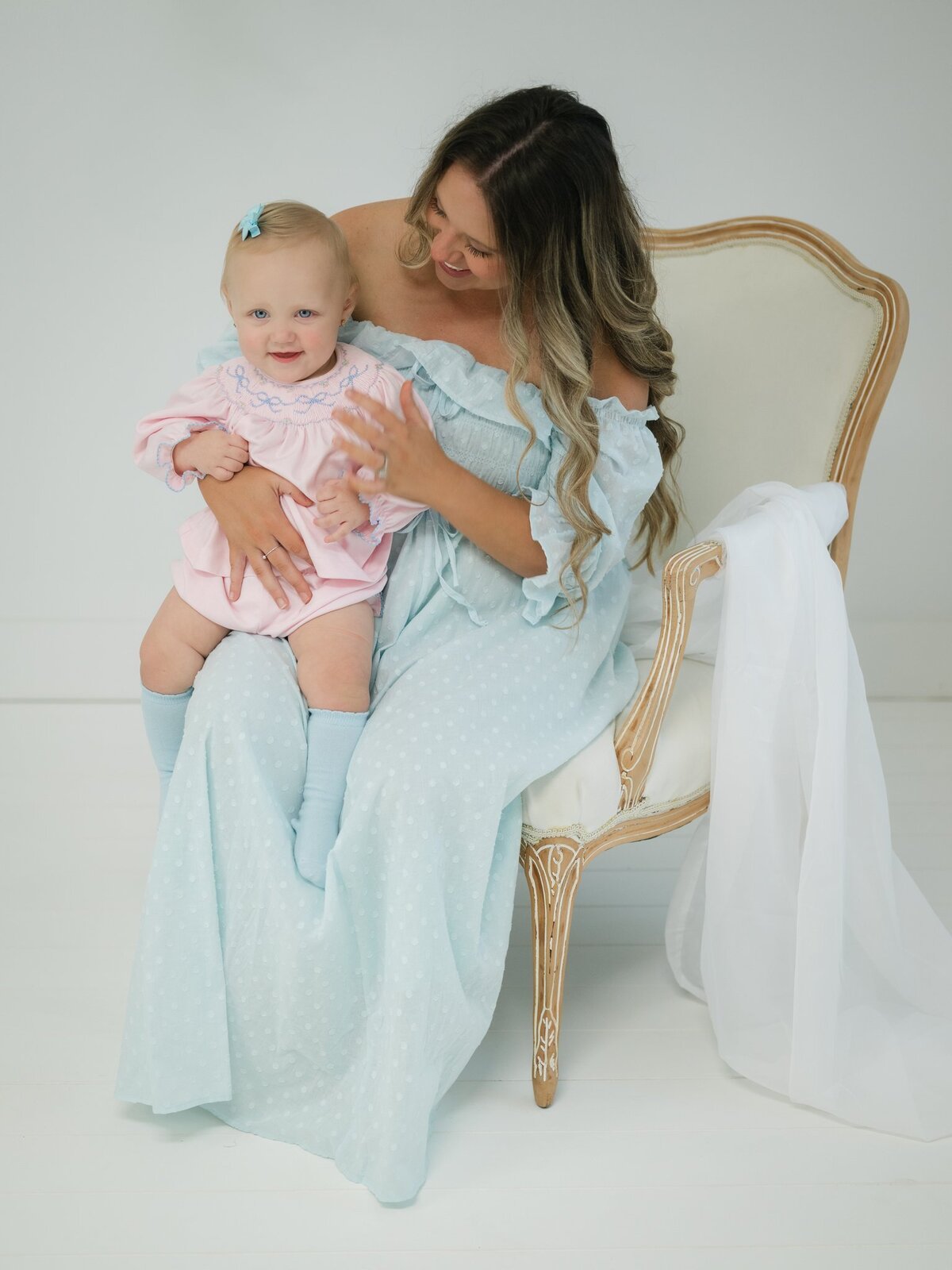 Smiling baby while moms holds her and loves on her. Serving mothers and babies across Southwest Georgia & Northwest Florida. 