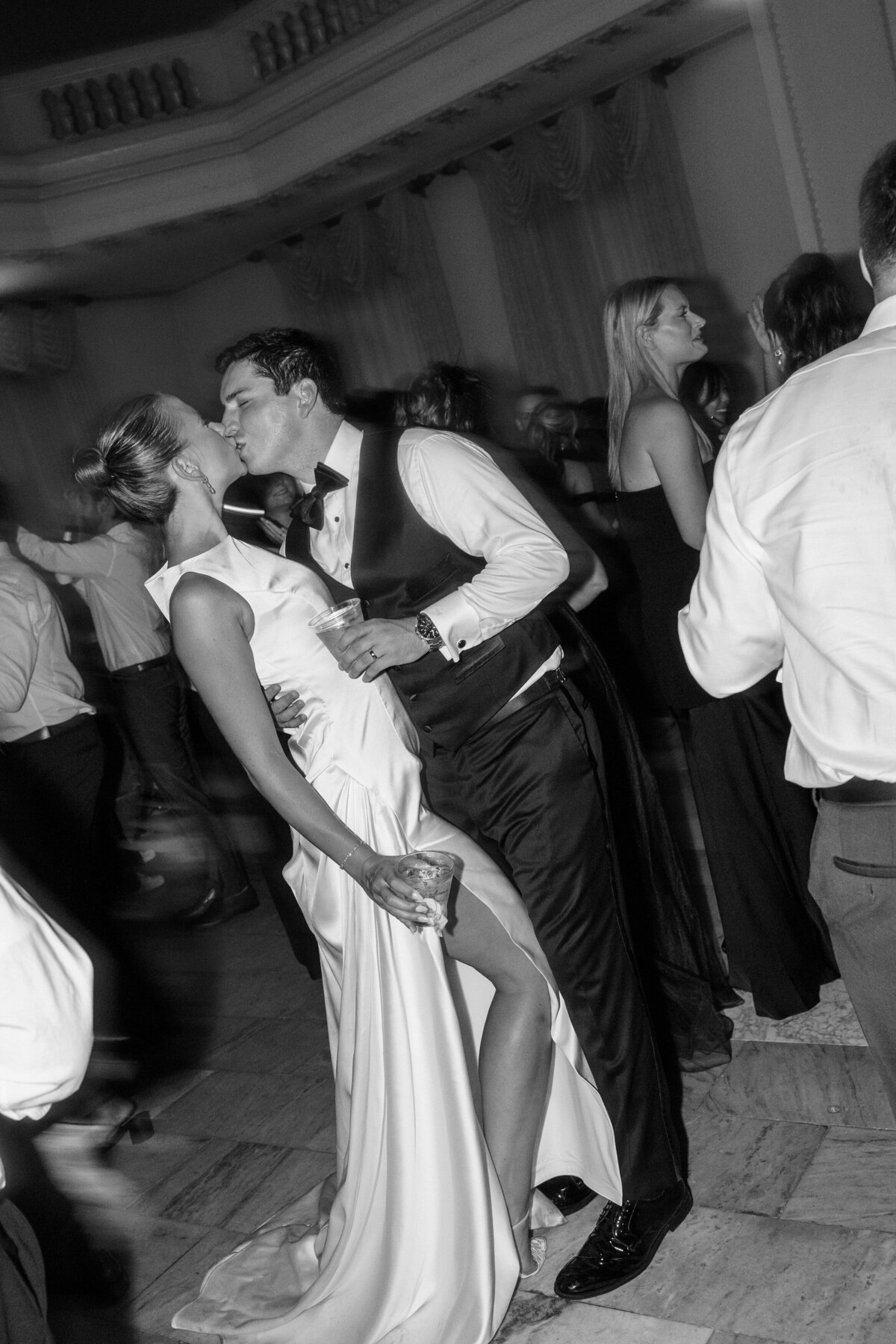Couple kisses on dance floor during Philly wedding reception, taken by Philadelphia wedding photographer.