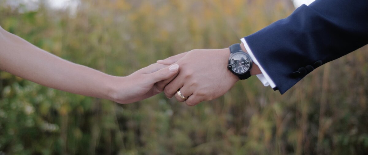 bride and groom holding hands