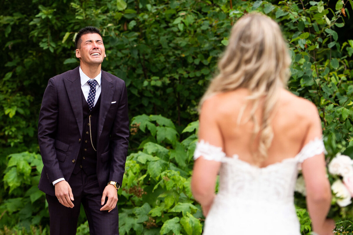 a groom crying heavily during first looks  at an Ottawa wedding at Le Belvedere wedding venue
