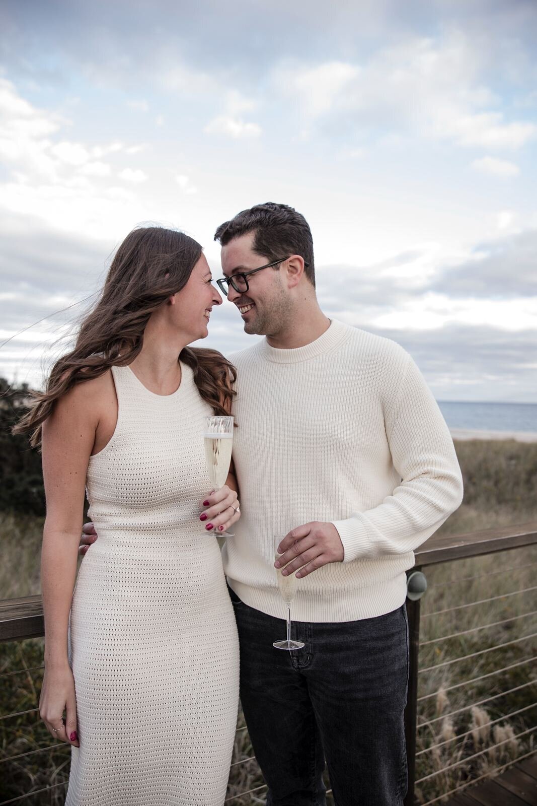 Couple enjoying champagne during their engagement session.