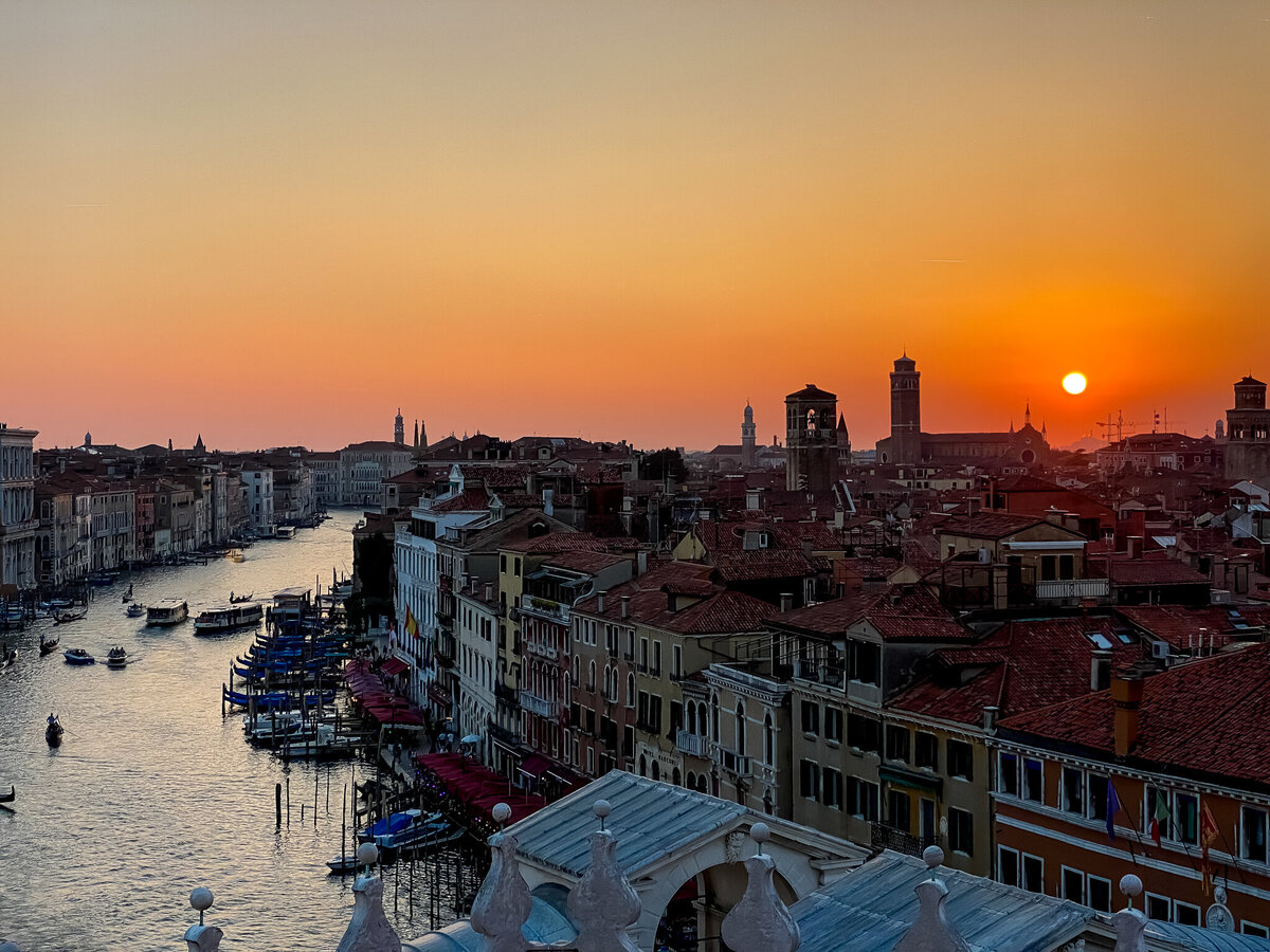The sun sets over the Grand Canal in Venice Italy.