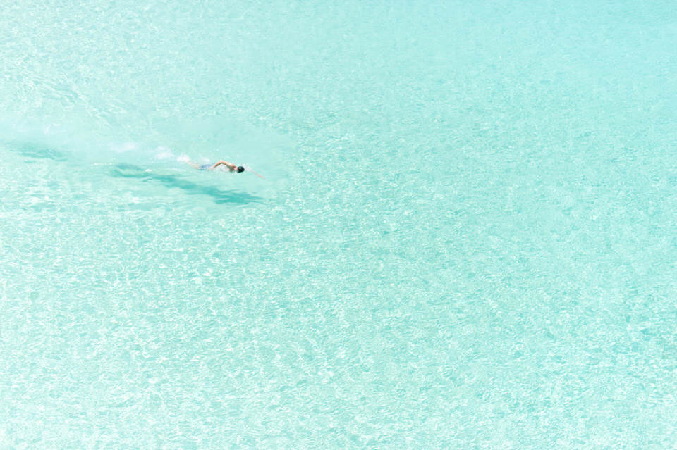 person swimming at meads bay in anguilla