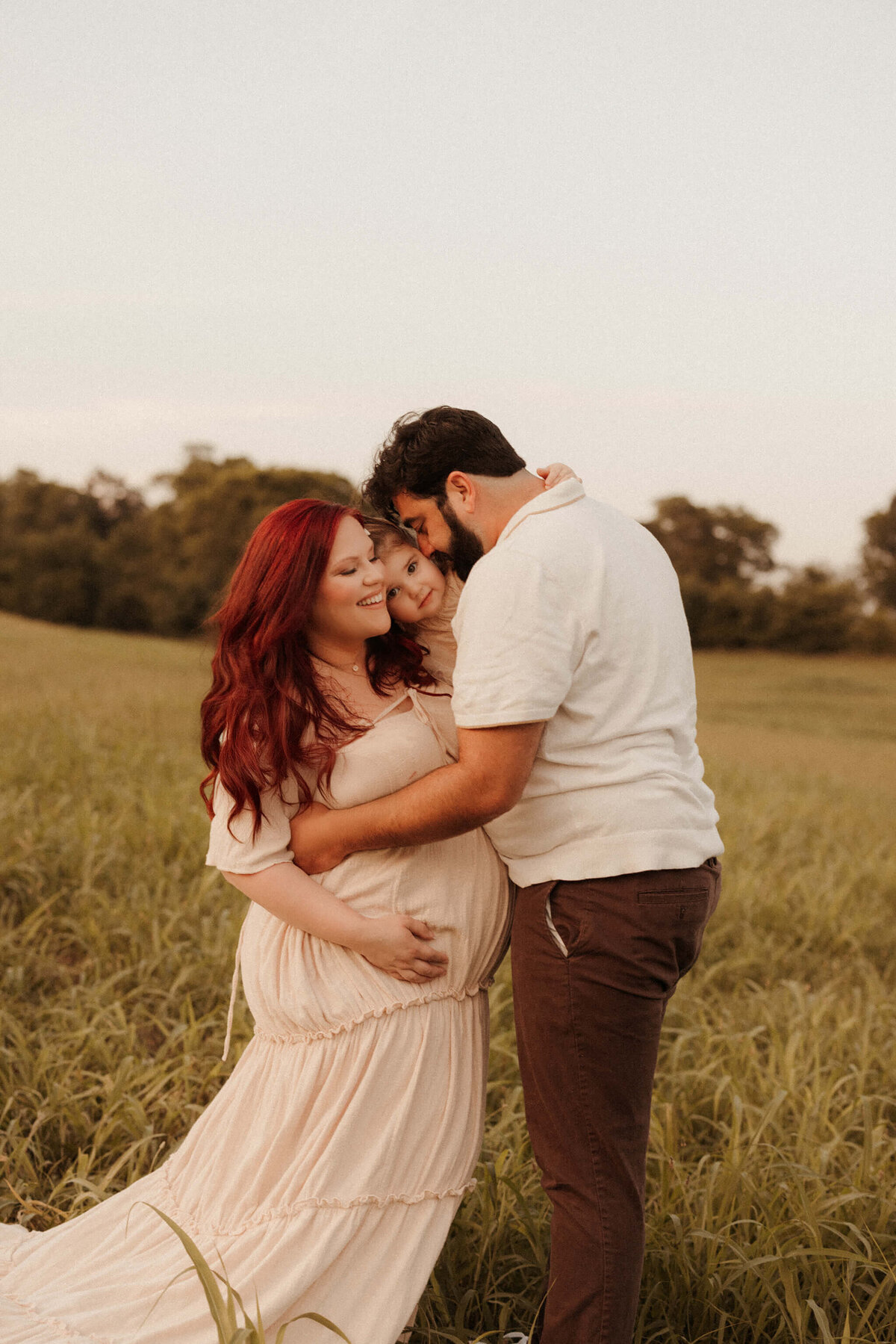 Expecting mother in soft pastel dress during Franklin TN outdoor maternity photo session