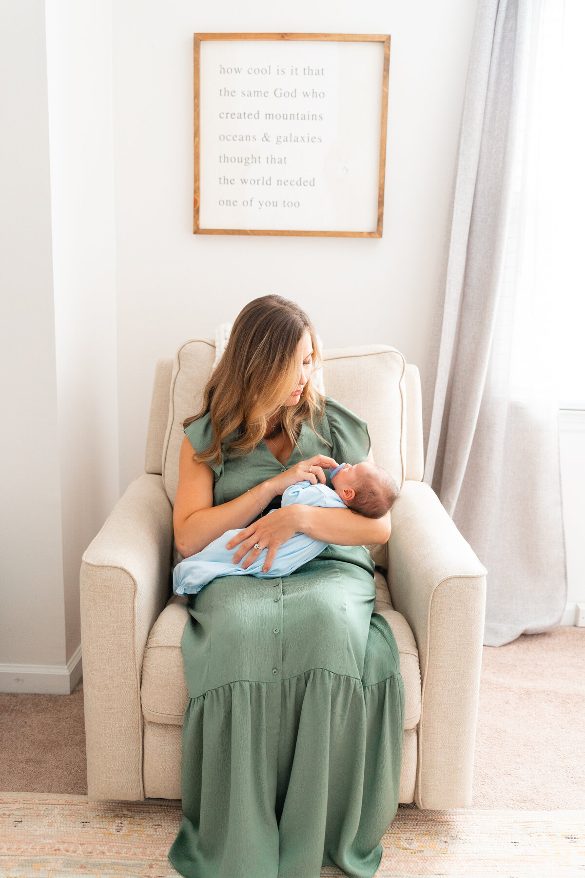 Chattanooga newborn photographer Kelley Hoagland takes lifestyle photos in-home location. Mother posed in nursery.
