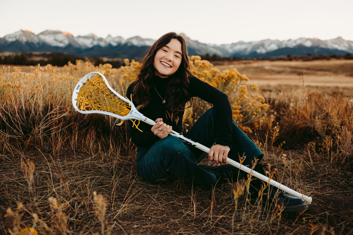 Savannah poses with her lacrosse stick for her Montrose senior pictures.